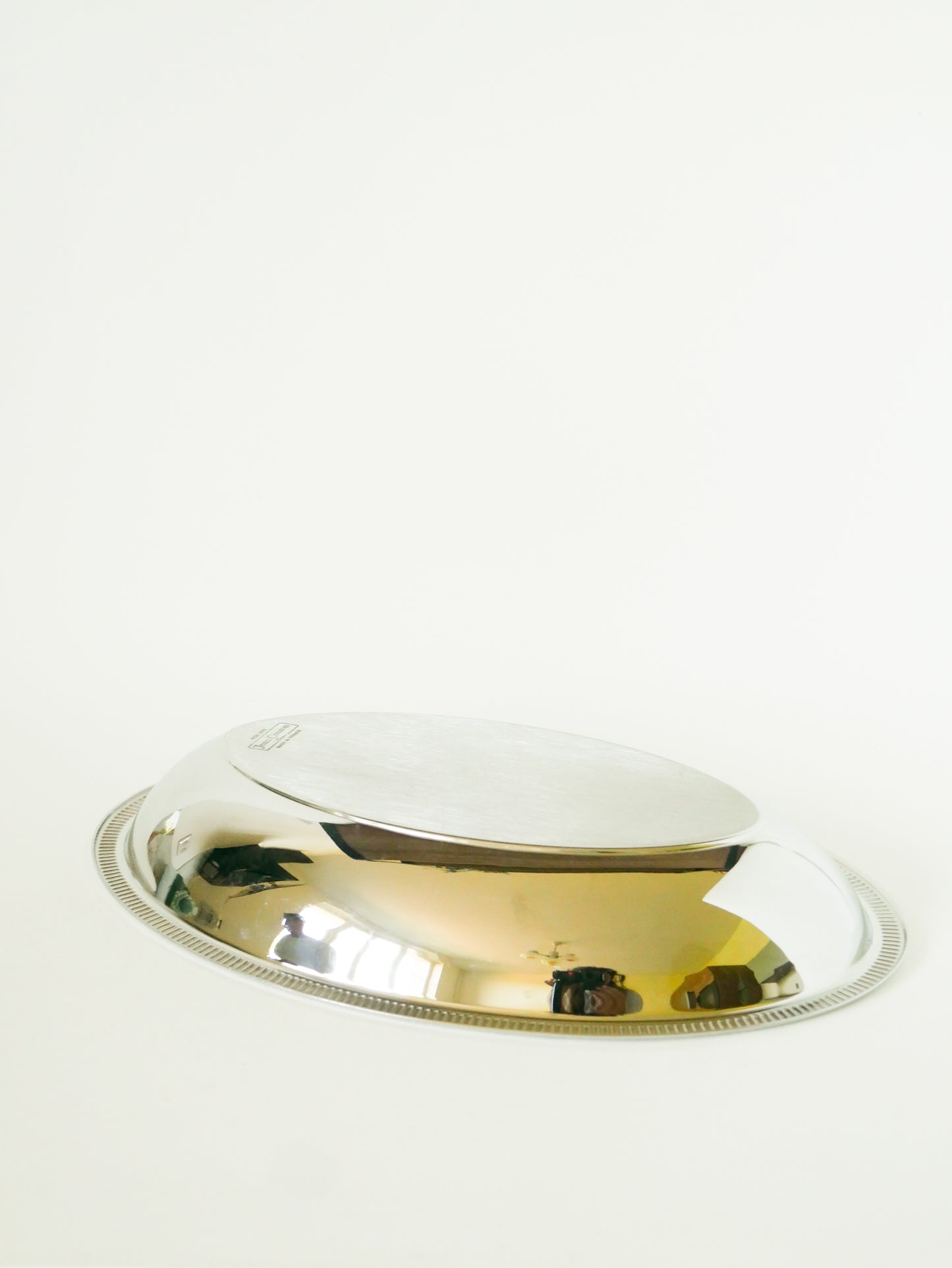 Grand plat oval en inox, signé Jean Couzon, 1970